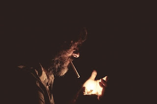 man lighting cigarette