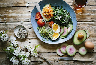 fruit salad with boiled egg in a plate on the table